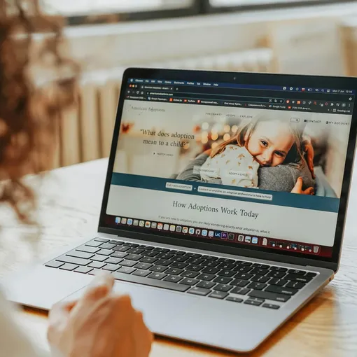 Framer responsive website on laptop Person viewing a responsive website design on a laptop, representing Framer website development and support