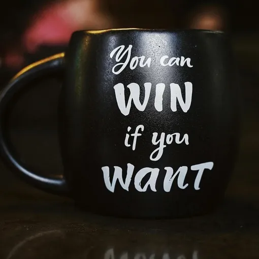Black coffee mug with motivational quote “You can win if you want” symbolising Stellar Digital Media’s SEO services helping businesses achieve measurable growth