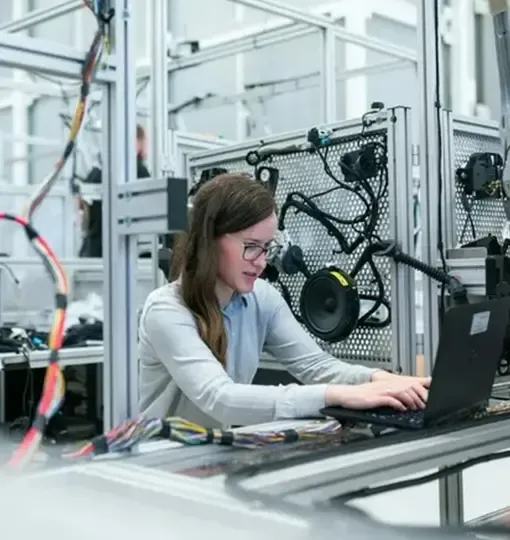 Woman working on computer with technical tools representing paid ads optimisation | Google Ads marketing agenc