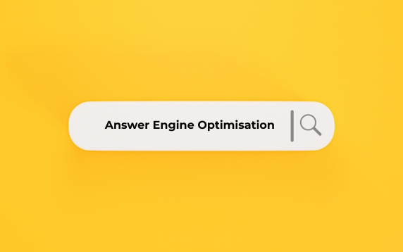 Answer Engine Optimisation An illustration of a white search bar containing the text "Answer Engine Optimisation" with a magnifying glass icon on the right, set against a solid yellow background.